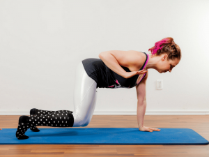 Nikki demonstrating a pilates shoulder exercise